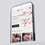 Smartphone displaying the beyond blessed website with a floral design on the screen.