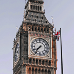 Close-up of the big ben tower with a Union Jack flag in the background