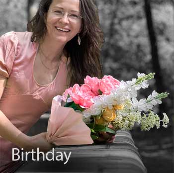 Woman holding a bouquet of pink, white and yellow flowers 